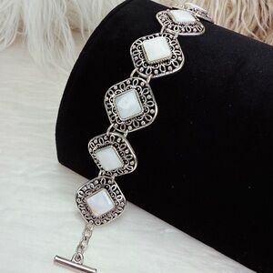 Beautiful Silvertone and white costume toggle closure bracelet